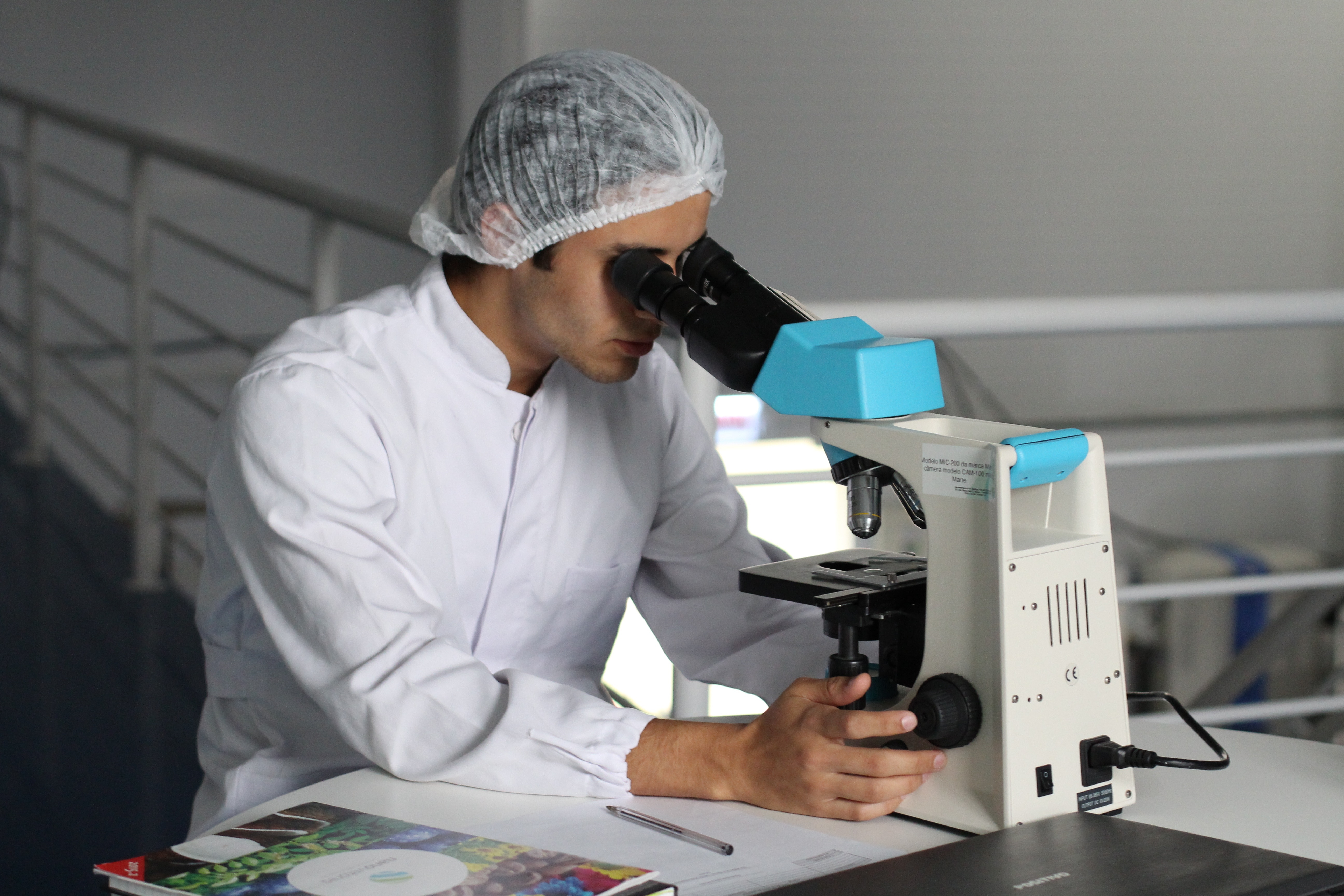 A man using a microscope. Photo by Lucas Vasques on Unsplash